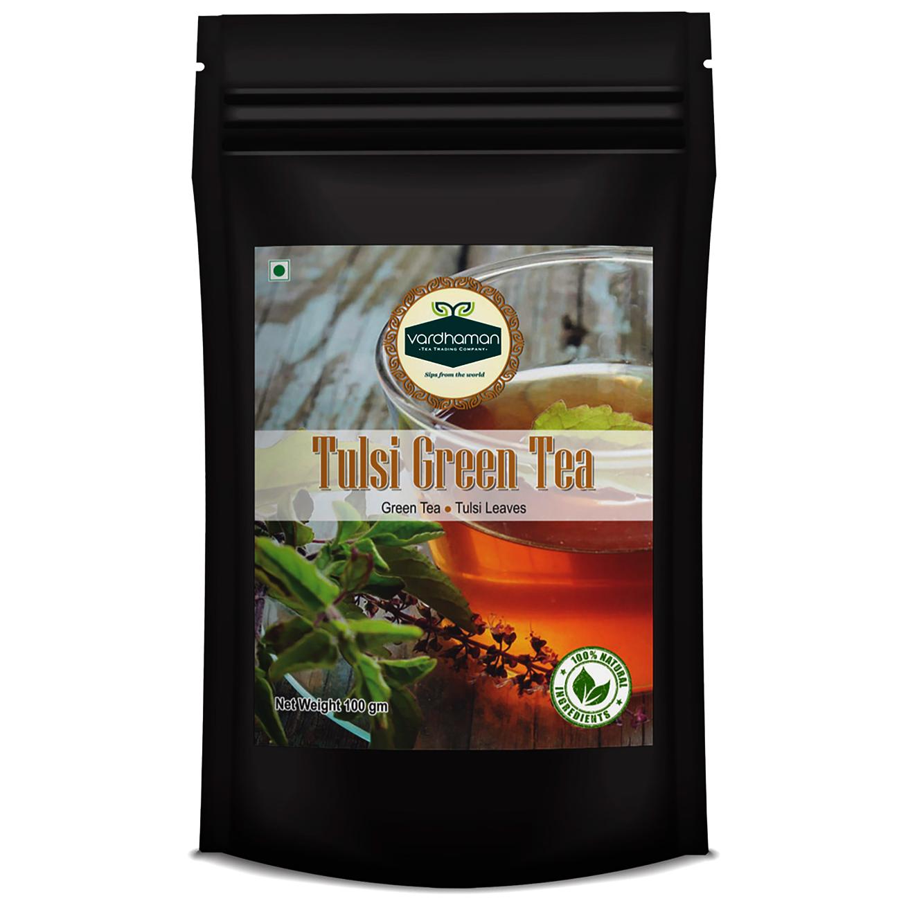 Black stand-up pouch of Vardhaman 100g Tulsi Green Tea, featuring a label with a glass of brewed tea and fresh tulsi leaves.
